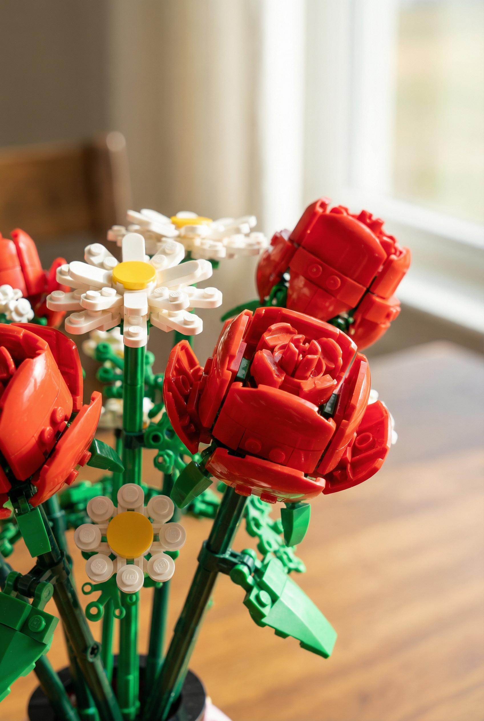 A macro shot of a beautiful bouquet of flowers built entirely from LEGO bricks, roses and daisies, plastic texture, dept