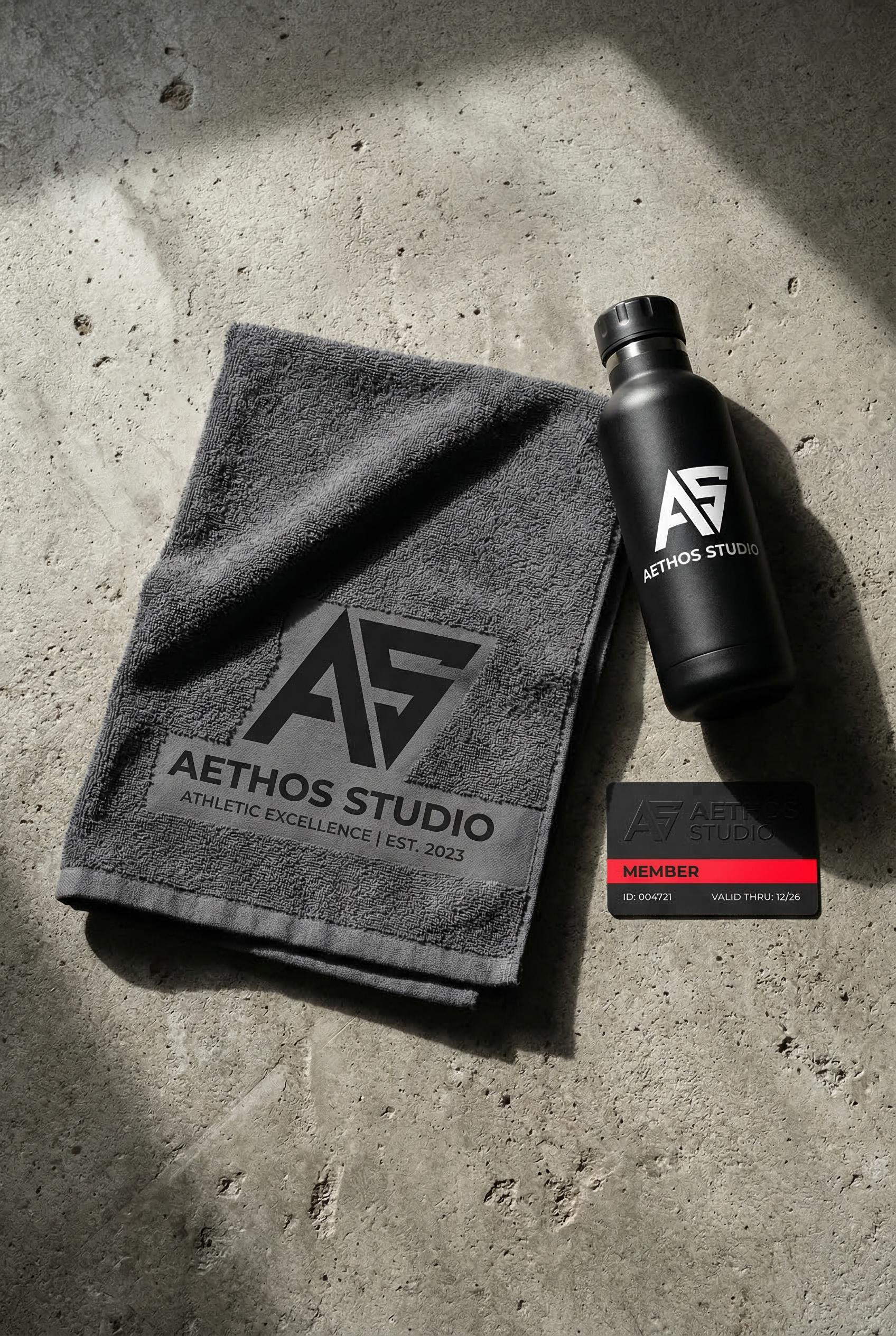 A modern fitness studio brand identity concept displayed on a raw concrete surface, featuring a bold geometric angular l