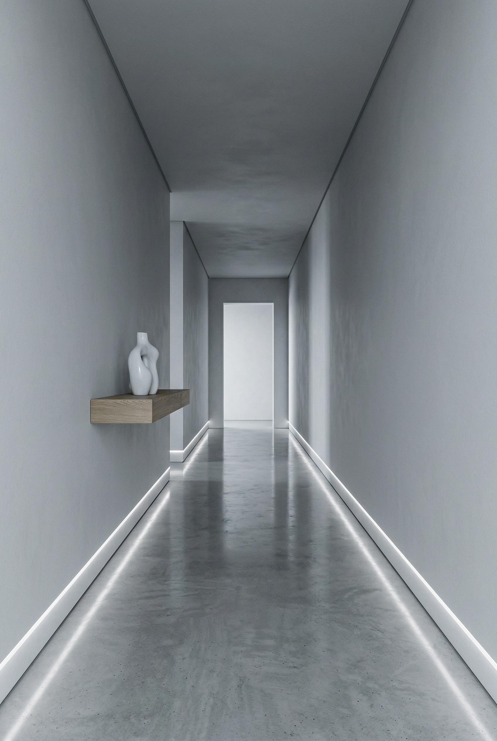 A monochrome minimalist hallway with polished concrete flooring reflecting subtle light, smooth pale grey p...