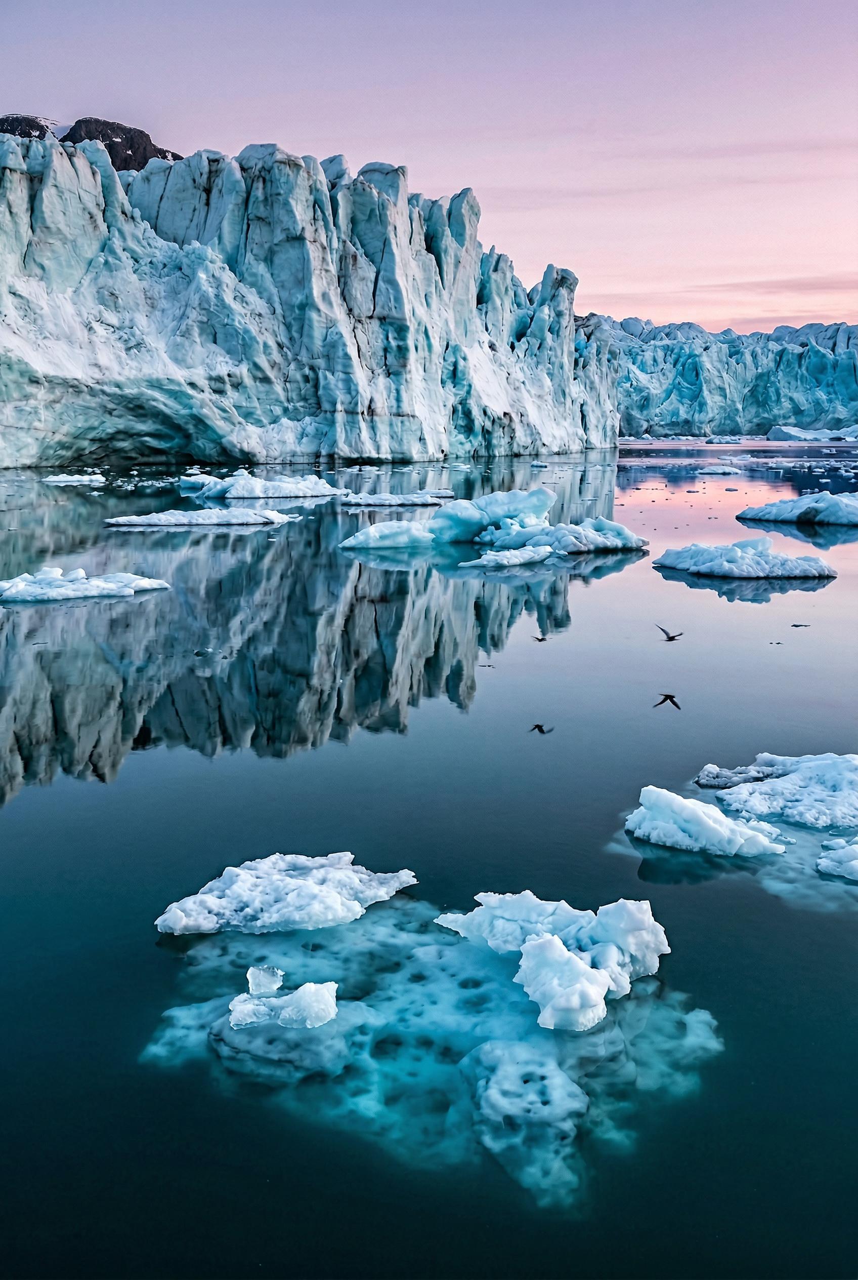 A breathtaking glacier landscape at the blue hour just after sunset, a massive ice wall of a glacier