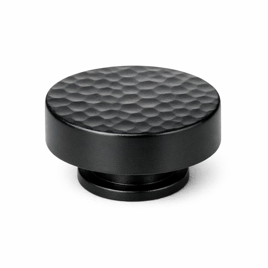 Commercial product photograph. A single residential cabinet knob. Hammered surface texture. Round Kn