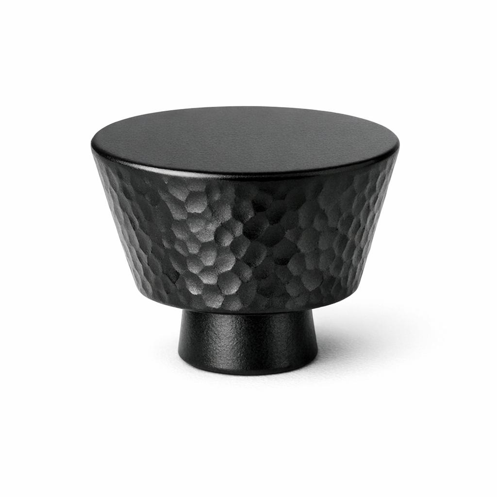 Commercial product photograph. A single residential cabinet knob. Hammered surface texture. Round Kn