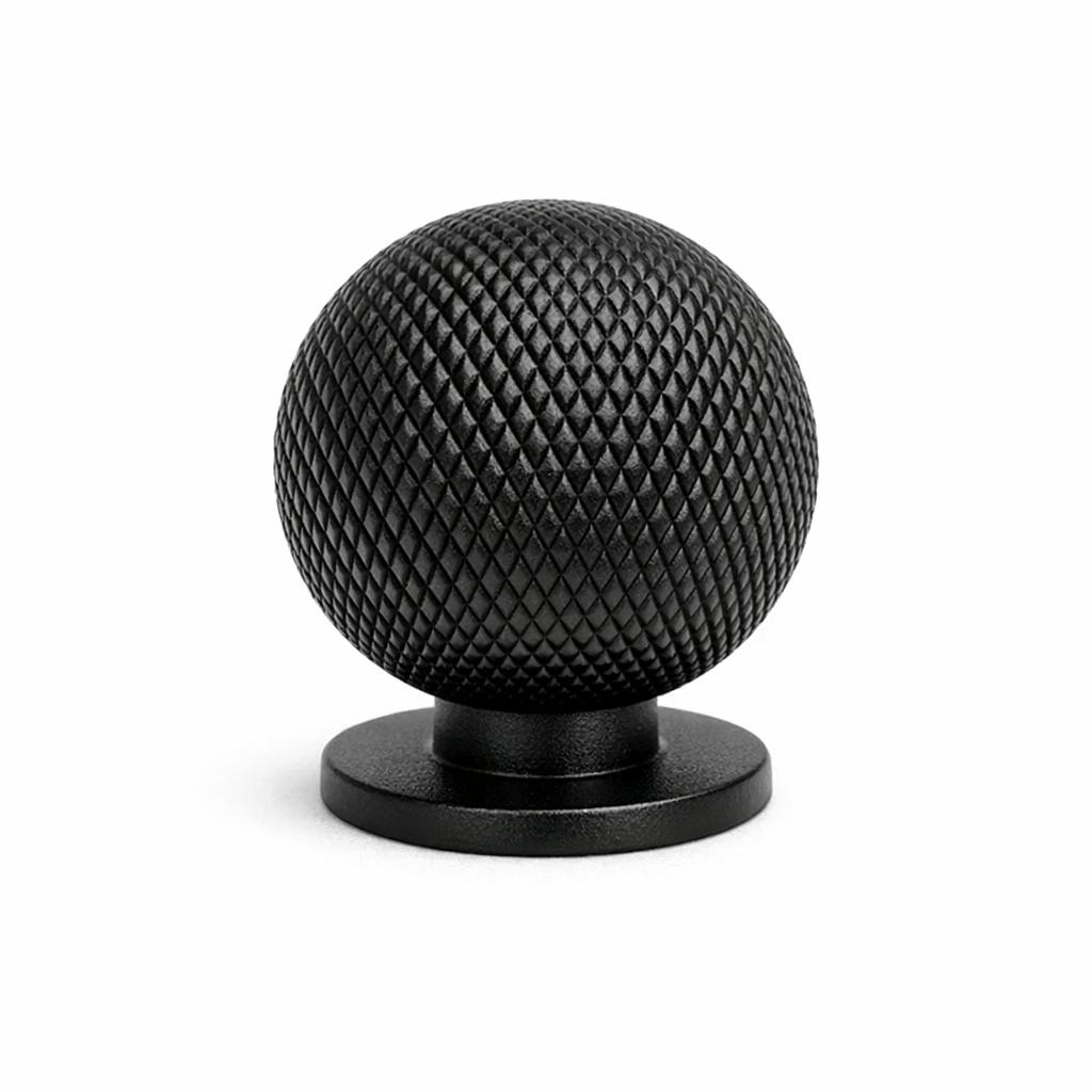 Commercial product photograph. A single residential cabinet knob. Knurled surface texture. Round Knob shape...