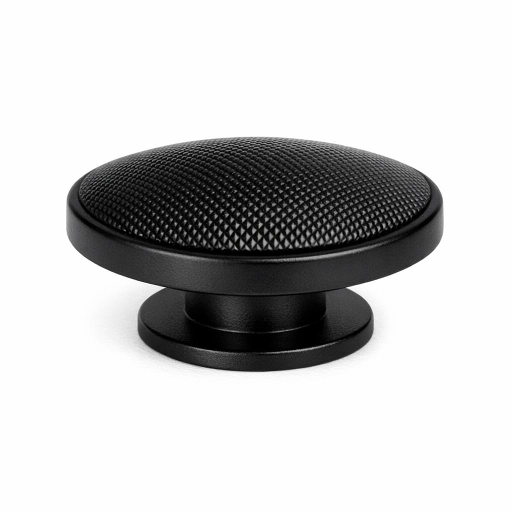 Commercial product photograph. A single residential cabinet knob. Knurled surface texture. Round Kno