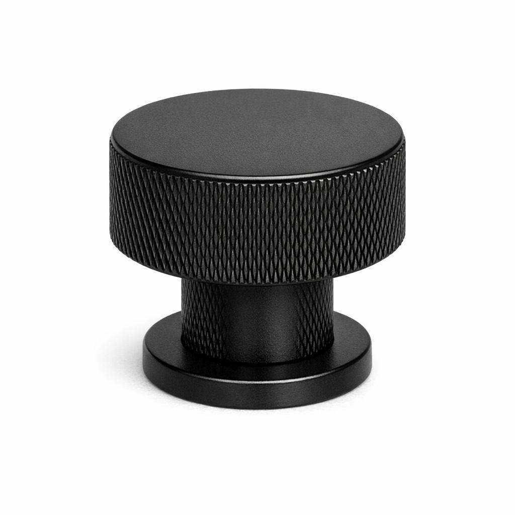 Commercial product photograph. A single residential cabinet knob. Knurled surface texture. Round Kno