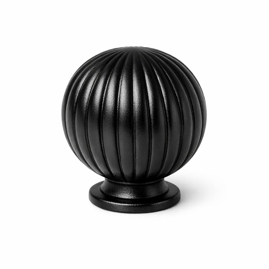 Commercial product photograph. A single residential cabinet knob. Ribbed surface texture. Round Knob shape....