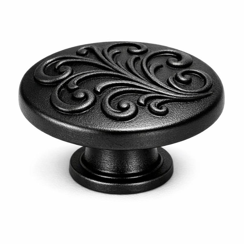 Commercial product photograph. A single residential cabinet knob. Scrollwork surface texture. Round Knob sh...