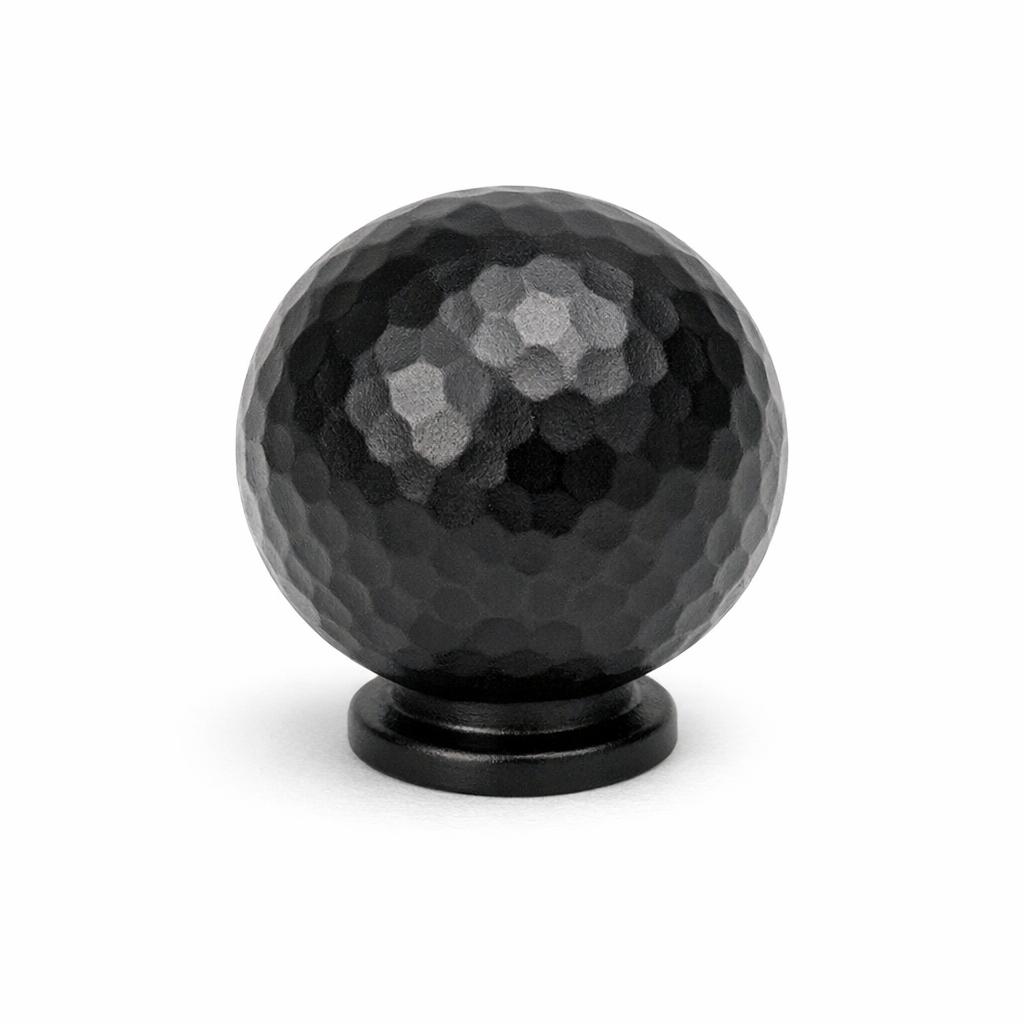 Commercial product photograph. A single residential cabinet knob. Hammered surface texture. Round Knob shap...