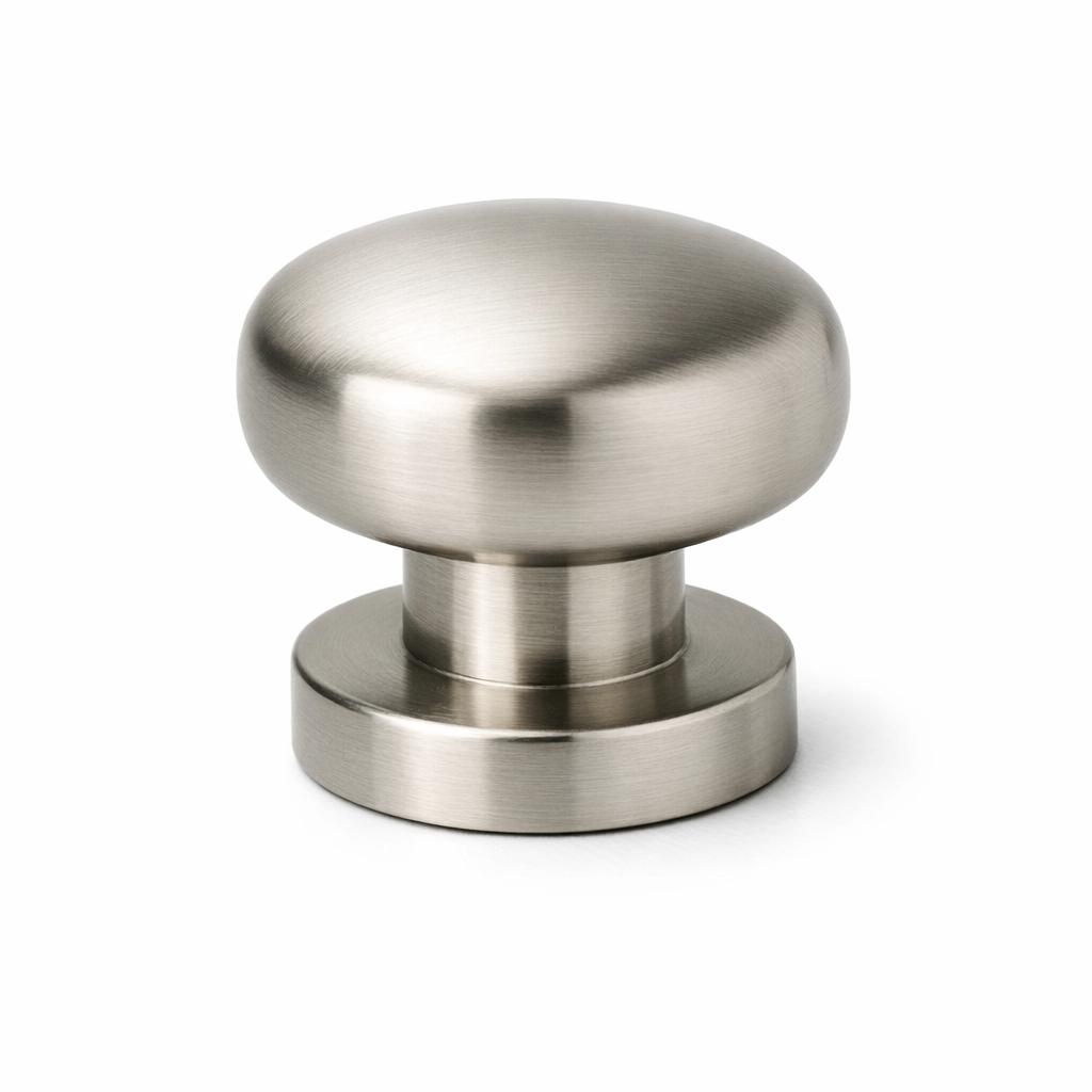Commercial product photograph. A single residential cabinet knob. Smooth surface texture. Round Knob shape. Brushed Nickel metal finish. Small circular base plate, single mounting post, approximately 1-1/4 inch diameter. Photographed on pure white seamless background (#FFFFFF). Studio softbox lighting, soft shadow directly underneath only. Macro lens, sharp focus throughout. Photorealistic real metal hardware. Not a 3D render. Not an illustration. Not CGI. Real cabinet hardware product photography quality. Variation 10: Podium style cabinet knob: round top sitting on a stepped cylindrical pedestal base, two distinct tiers visible, mid-century modern style. Smooth surface, no texture, no ribbing, no decorative details..