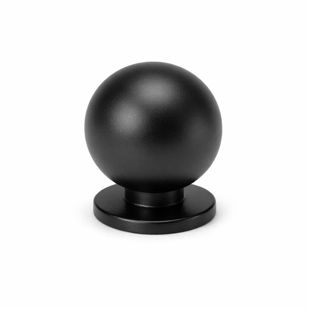 Commercial product photograph. A single residential cabinet knob. Smooth surface texture. Round Knob shape. Matte Black 
