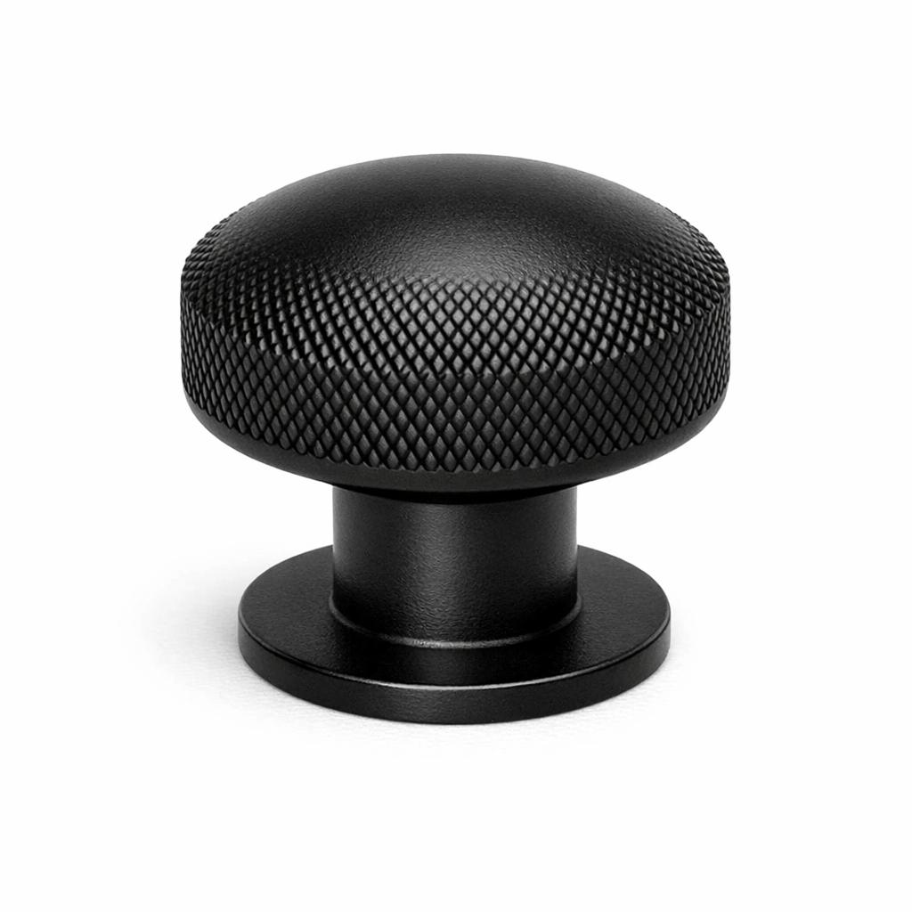 Commercial product photograph. A single residential cabinet knob. Knurled surface texture. Round Kno