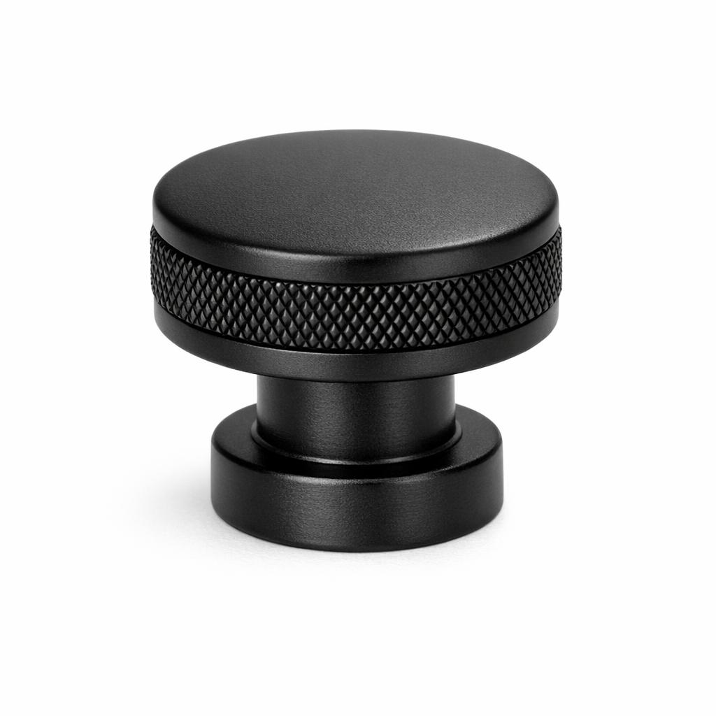 Commercial product photograph. A single residential cabinet knob. Knurled surface texture. Round Kno