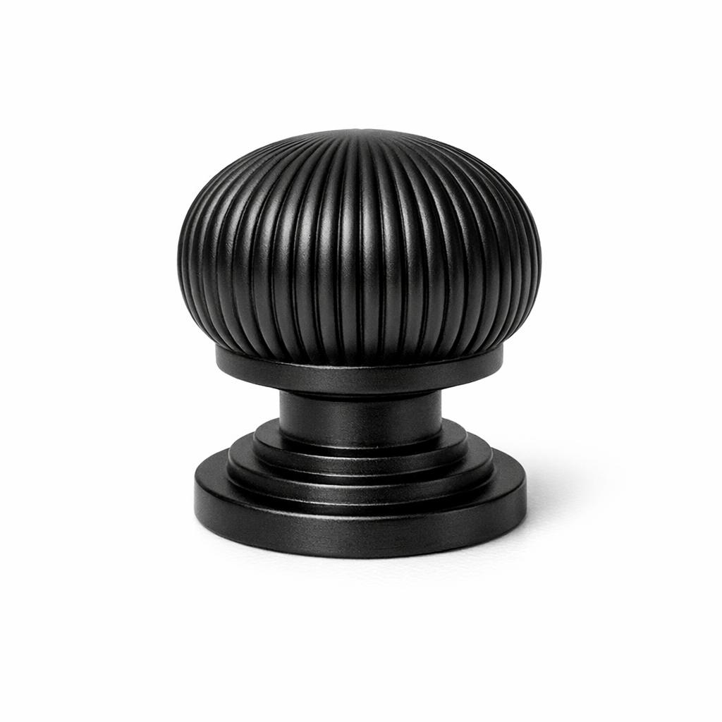 Commercial product photograph. A single residential cabinet knob. Ribbed surface texture. Round Knob shape....