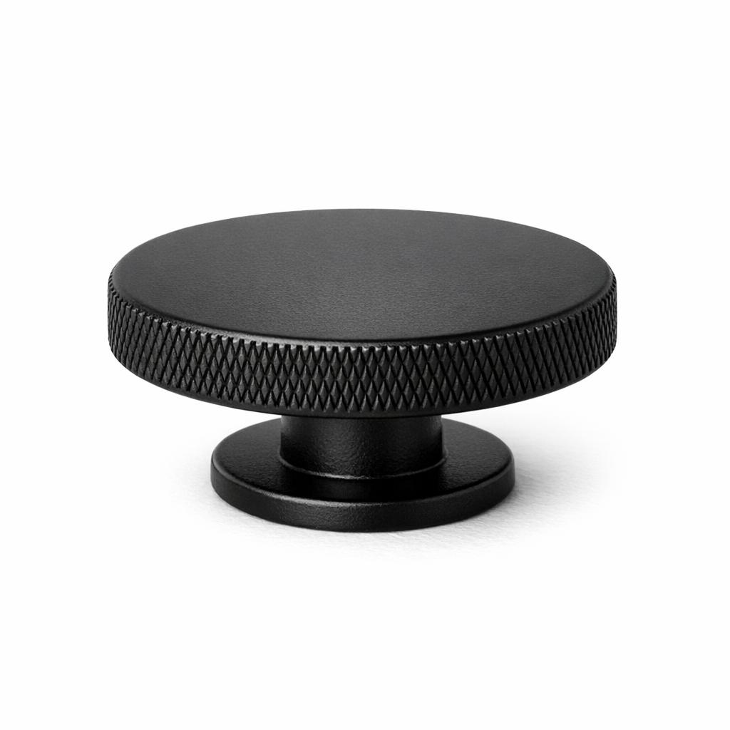 Commercial product photograph. A single residential cabinet knob. Knurled surface texture. Round Kno