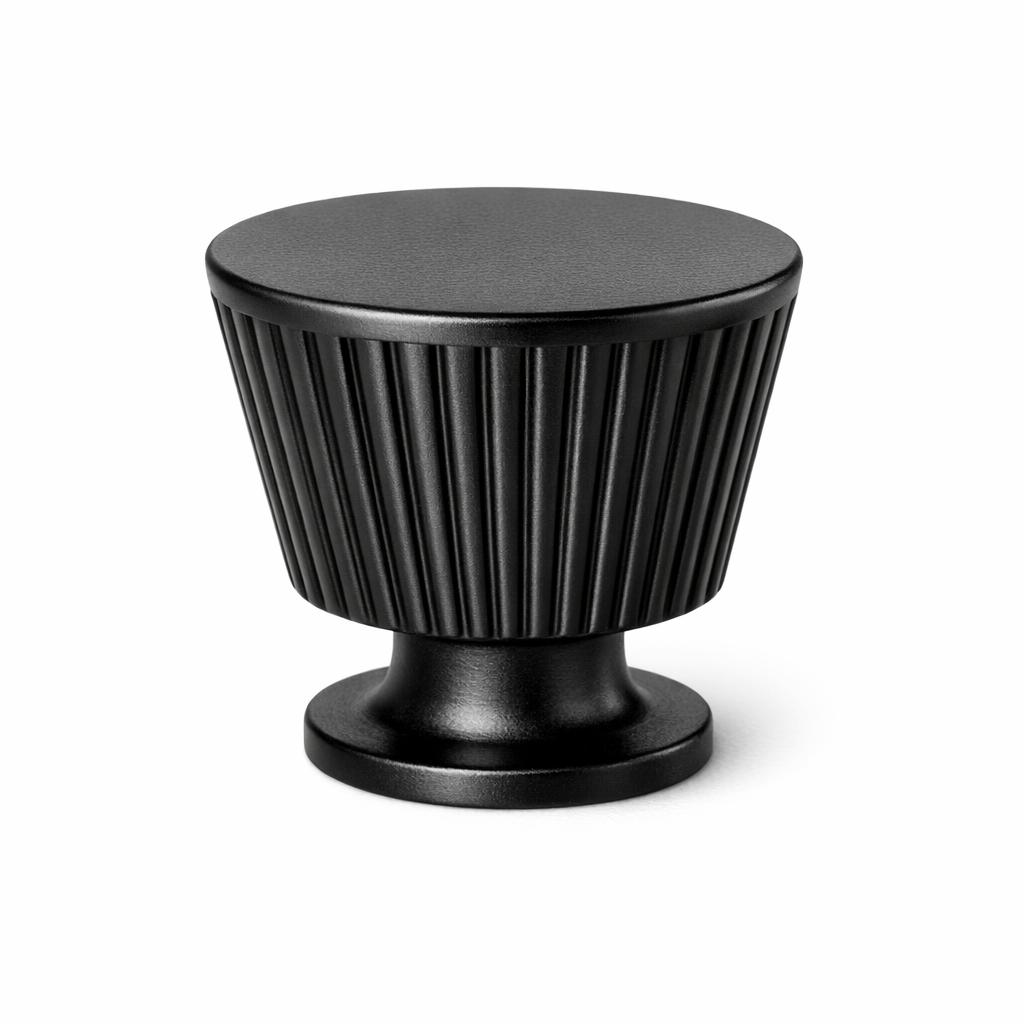 Commercial product photograph. A single residential cabinet knob. Ribbed surface texture. Round Knob shape....