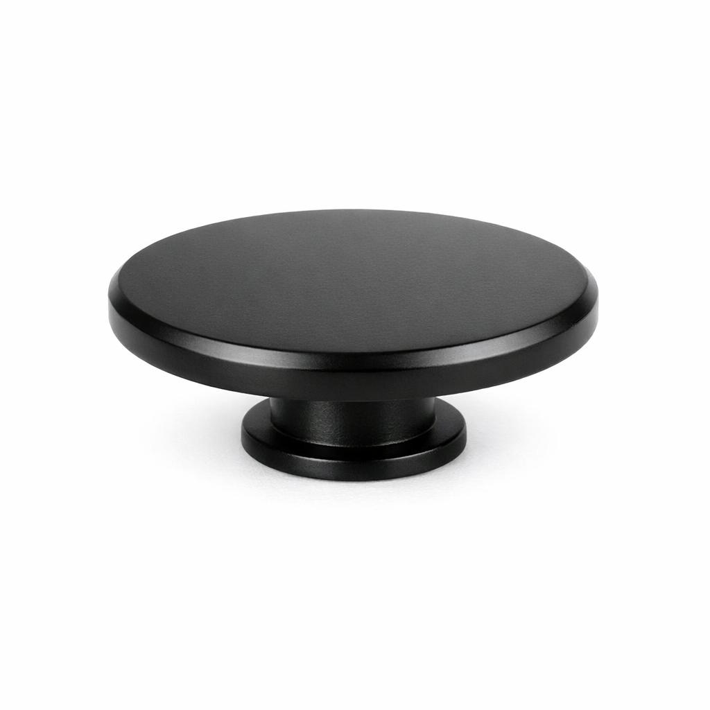 Commercial product photograph. A single residential cabinet knob. Smooth surface texture. Round Knob shape. Matte Black 