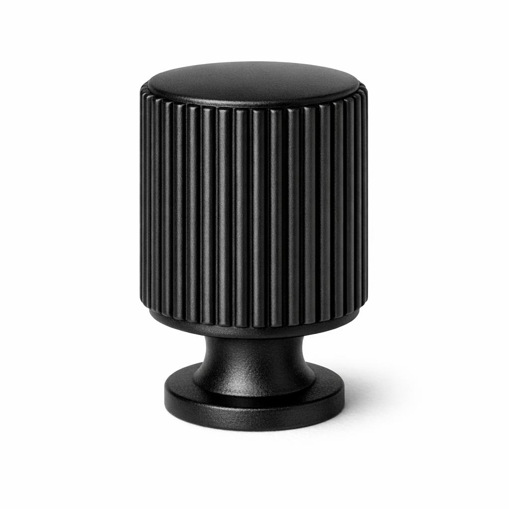 Commercial product photograph. A single residential cabinet knob. Ribbed surface texture. Round Knob shape. Matte Black 
