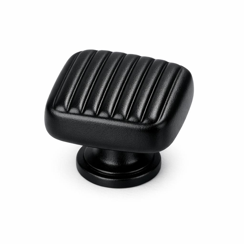 Commercial product photograph. A single residential cabinet knob. Ribbed surface texture. Round Knob shape. Matte Black 