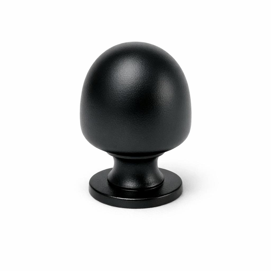 Commercial product photograph. A single residential cabinet knob. Smooth surface texture. Round Knob shape. Matte Black metal finish. Small circular base plate, single mounting post, approximately 1-1/4 inch diameter. Photographed on pure white seamless background (#FFFFFF). Studio softbox lighting, soft shadow directly underneath only. Macro lens, sharp focus throughout. Photorealistic real metal hardware. Not a 3D render. Not an illustration. Not CGI. Real cabinet hardware product photography quality. Variation 1: Providence style cabinet knob: tall rounded mushroom dome, clearly taller than it is wide, narrow short neck, small circular base plate. Smooth surface, no texture, no ribbing, no decorative details..