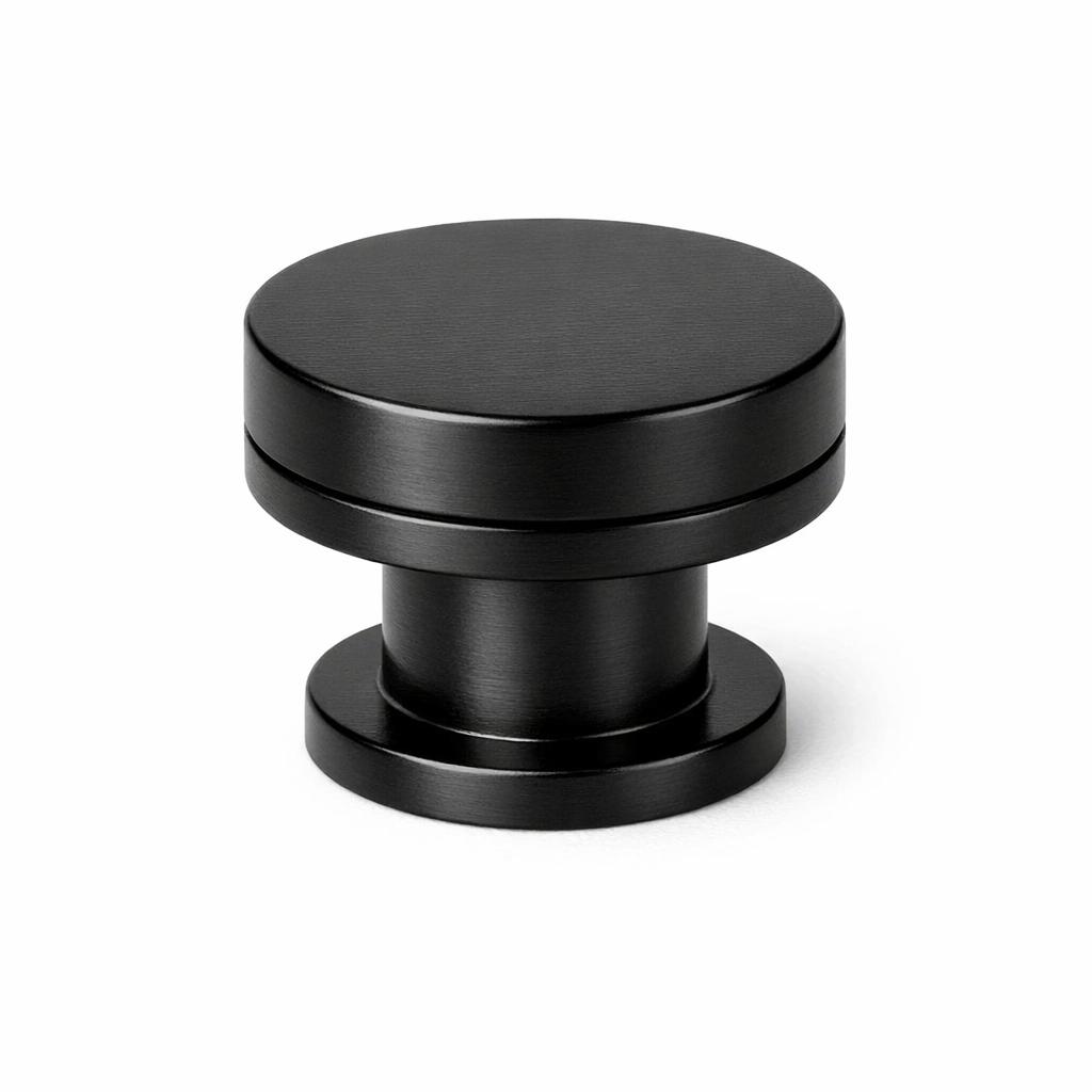 Commercial product photograph. A single residential cabinet knob. Smooth surface texture. Round Knob shape. Matte Black 