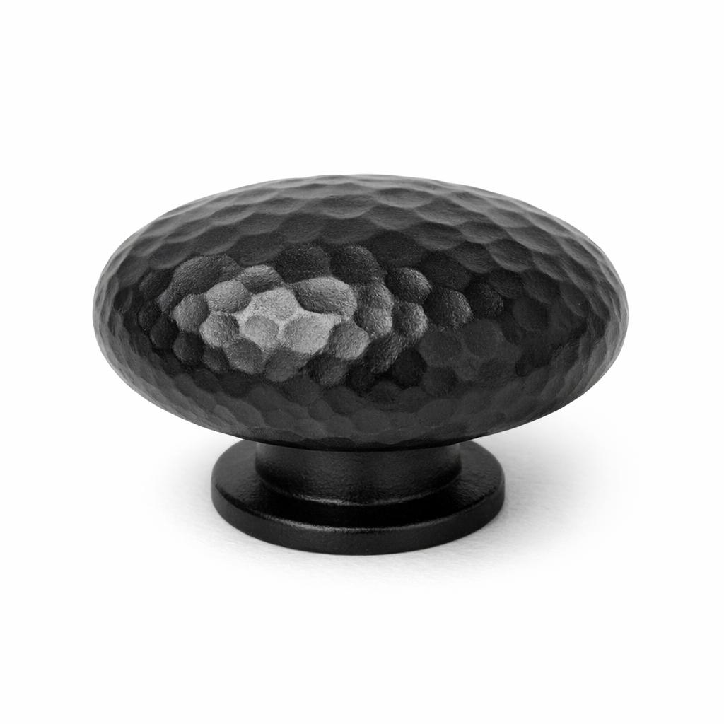 Commercial product photograph. A single residential cabinet knob. Hammered surface texture. Round Knob shap...