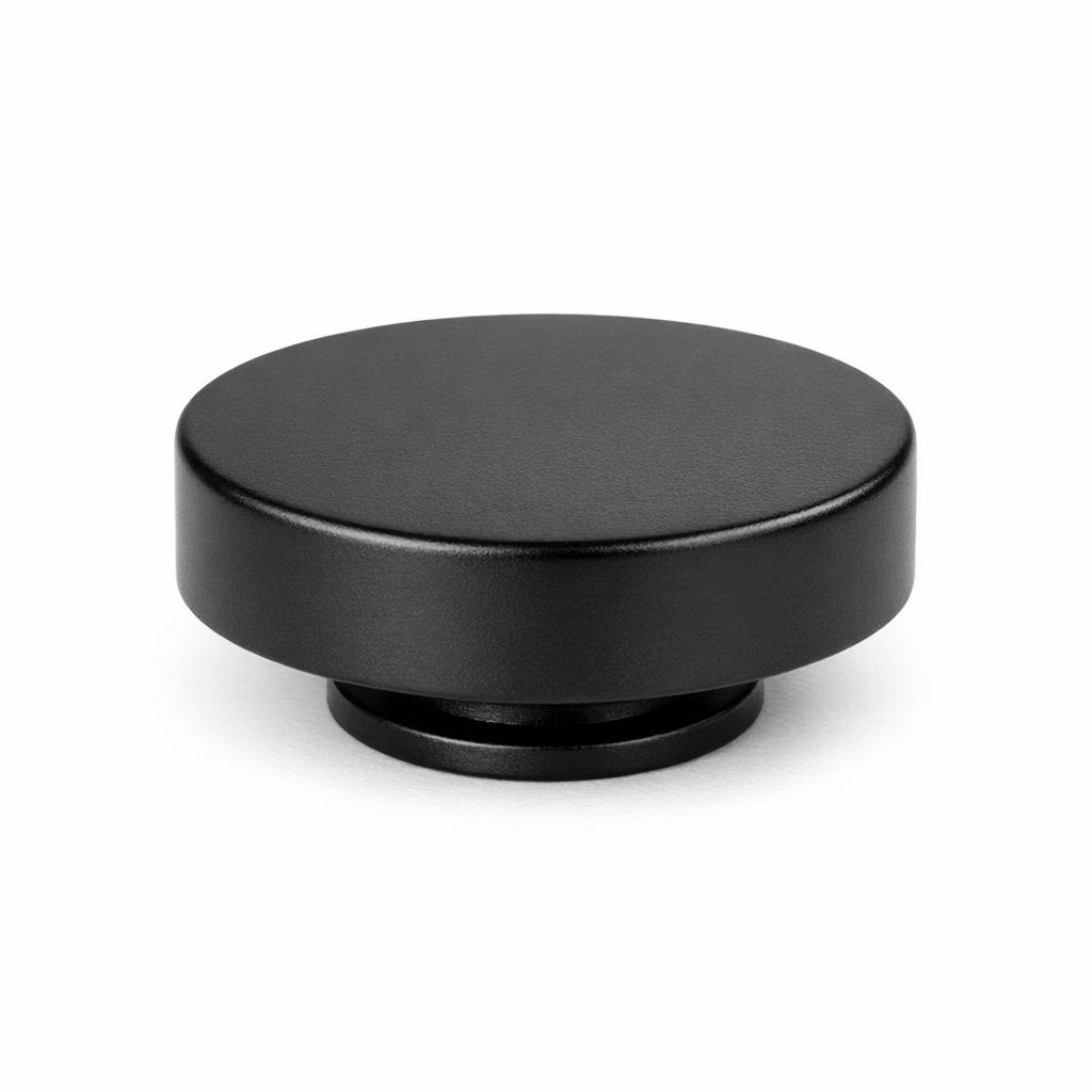Commercial product photograph. A single residential cabinet knob. Smooth surface texture. Round Knob shape. Matte Black 