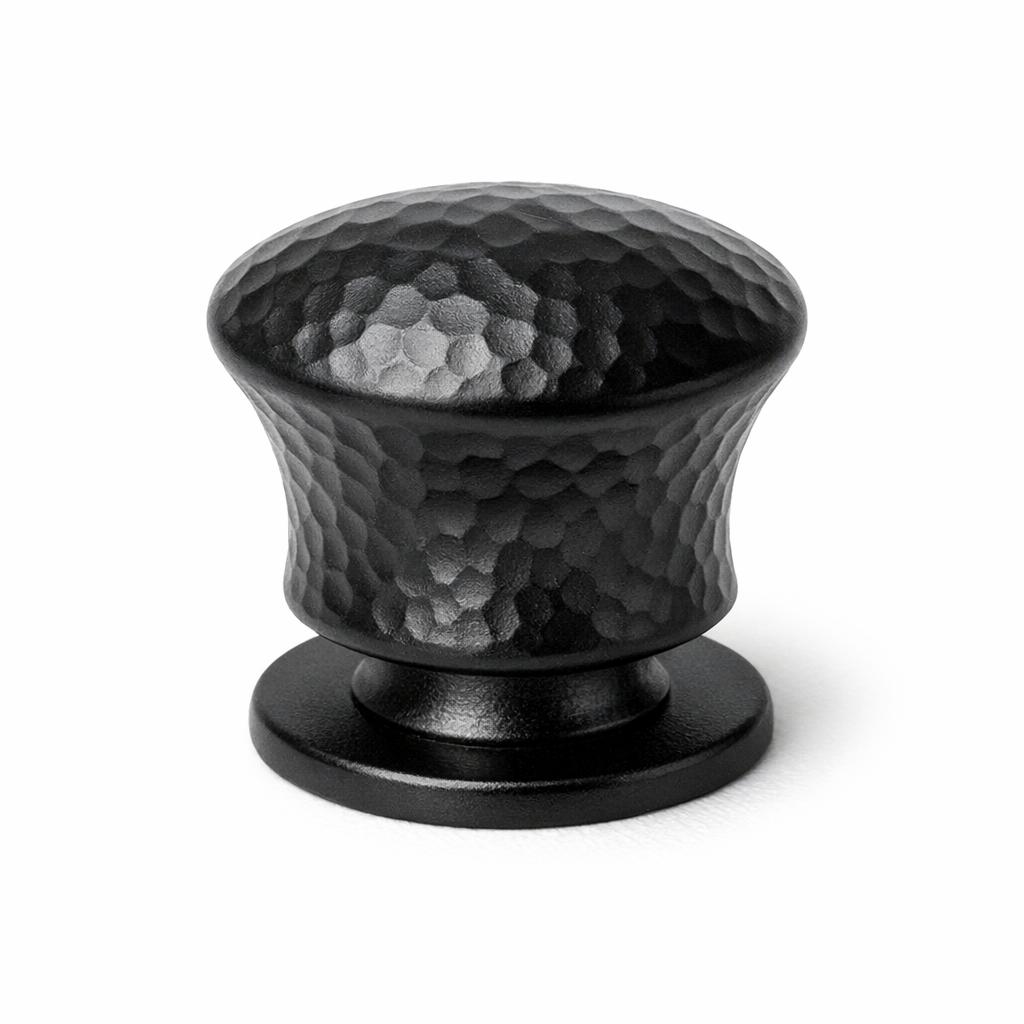 Commercial product photograph. A single residential cabinet knob. Hammered surface texture. Round Kn