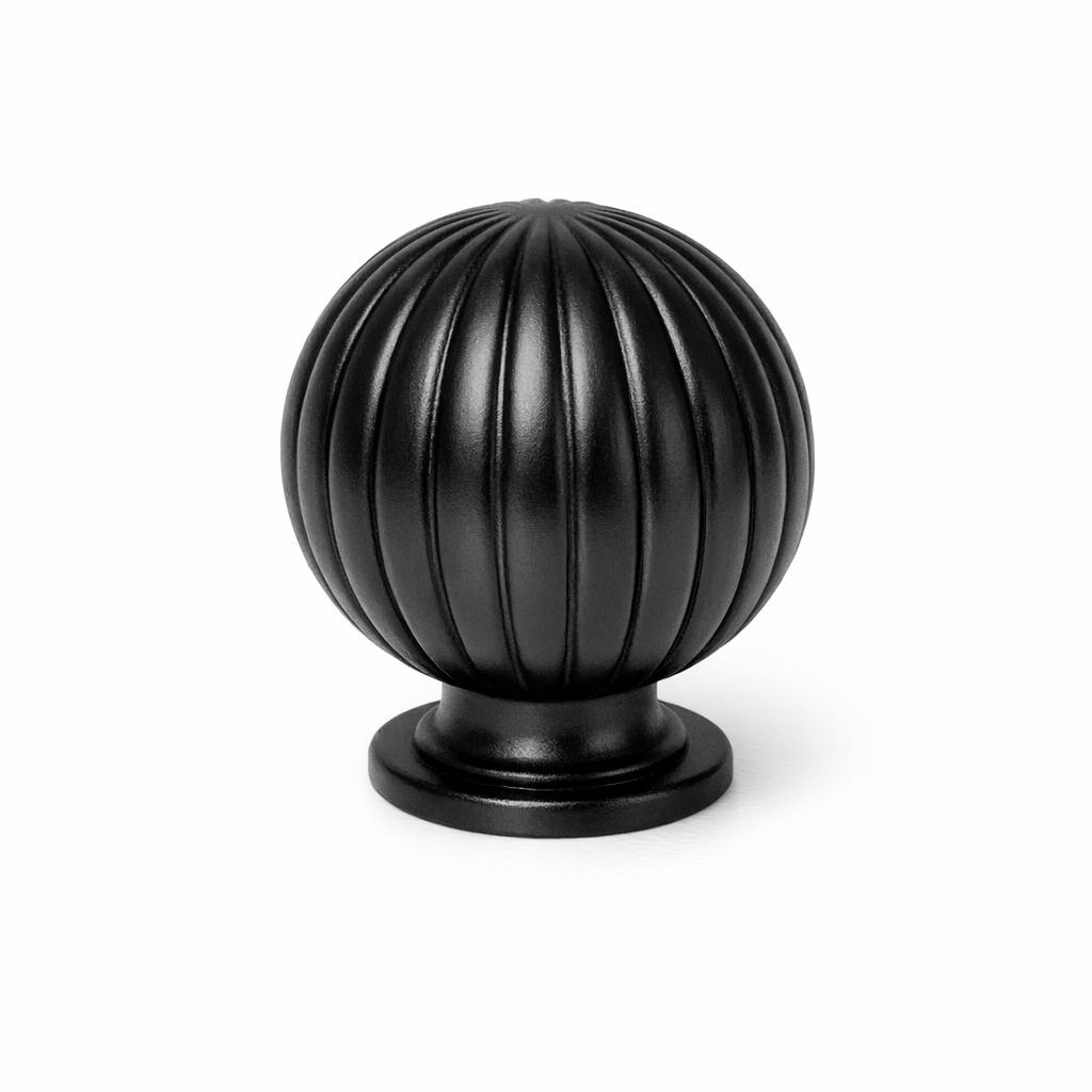 Commercial product photograph. A single residential cabinet knob. Ribbed surface texture. Round Knob shape. Matte Black 