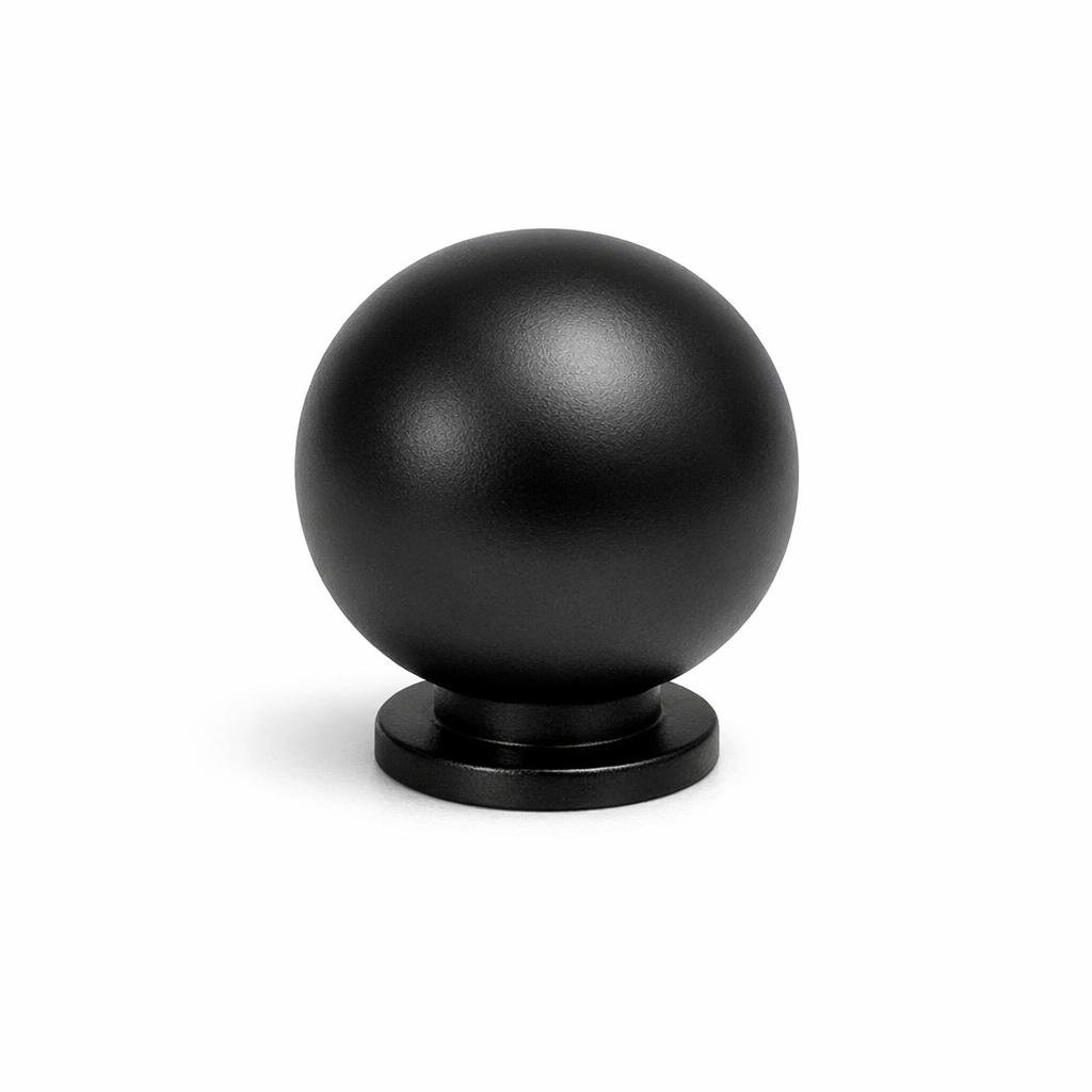 Commercial product photograph. A single residential cabinet knob. Smooth surface texture. Round Knob shape. Matte Black metal finish. Small circular base plate, single mounting post, approximately 1-1/4 inch diameter. Photographed on pure white seamless background (#FFFFFF). Studio softbox lighting, soft shadow directly underneath only. Macro lens, sharp focus throughout. Photorealistic real metal hardware. Not a 3D render. Not an illustration. Not CGI. Real cabinet hardware product photography quality. Variation 3: Globe style cabinet knob: a perfect solid sphere, full round ball shape, attached to a small narrow base ring underneath. Smooth surface, no texture, no ribbing, no decorative details..