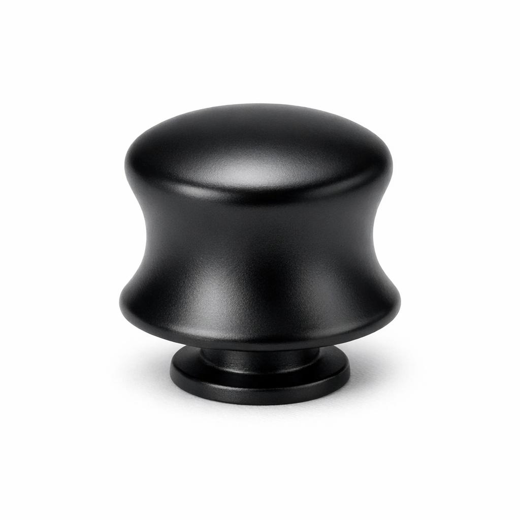 Commercial product photograph. A single residential cabinet knob. Smooth surface texture. Round Knob shape. Matte Black metal finish. Small circular base plate, single mounting post, approximately 1-1/4 inch diameter. Photographed on pure white seamless background (#FFFFFF). Studio softbox lighting, soft shadow directly underneath only. Macro lens, sharp focus throughout. Photorealistic real metal hardware. Not a 3D render. Not an illustration. Not CGI. Real cabinet hardware product photography quality. Variation 5: Overland style cabinet knob: a bell shape with concave flared sides curving outward from a rounded top down to a wide base, like a small bell. Smooth surface, no texture, no ribbing, no decorative details..