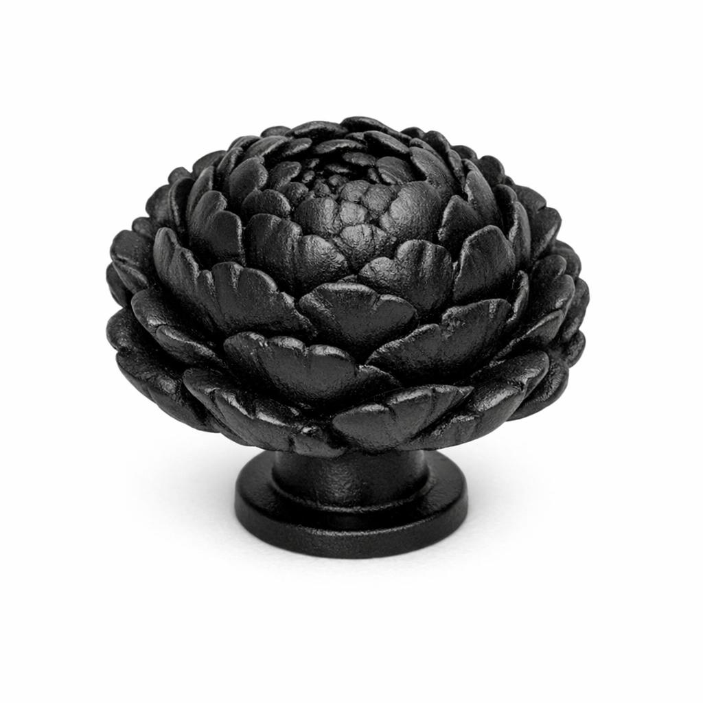 Commercial product photograph. A single residential cabinet knob. Floral surface texture. Round Knob shape. Matte Black metal finish. Small circular base plate, single mounting post, approximately 1-1/4 inch diameter. Photographed on pure white seamless background (#FFFFFF). Studio softbox lighting, soft shadow directly underneath only. Macro lens, sharp focus throughout. Photorealistic real metal hardware. Not a 3D render. Not an illustration. Not CGI. Real cabinet hardware product photography quality. Variation 4: Cabinet knob sculpted as a single full-bloom peony, many deep ruffled overlapping petals forming a rounded dome of petals, richly three-dimensional, small round base. Cast metal floral hardware..