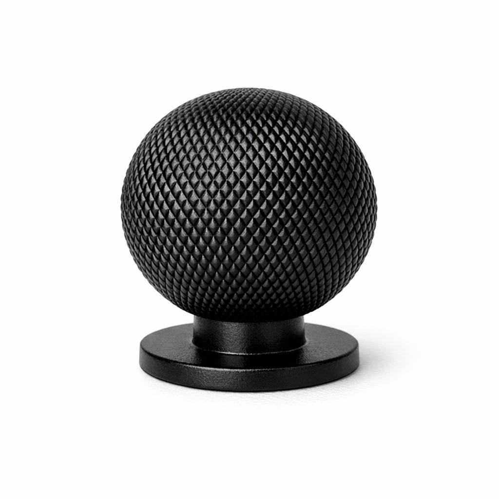 Commercial product photograph. A single residential cabinet knob. Knurled surface texture. Round Kno