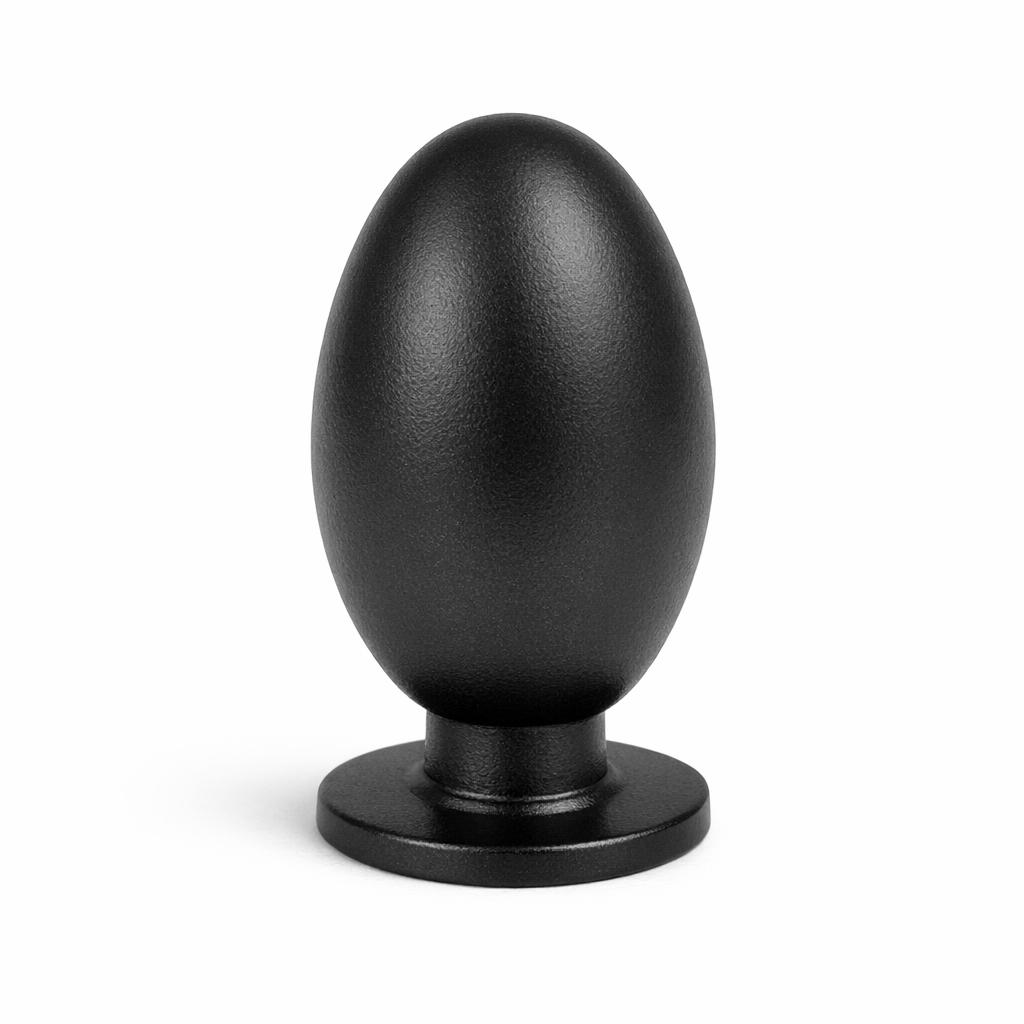 Commercial product photograph. A single residential cabinet knob. Smooth surface texture. Round Knob shape. Matte Black metal finish. Small circular base plate, single mounting post, approximately 1-1/4 inch diameter. Photographed on pure white seamless background (#FFFFFF). Studio softbox lighting, soft shadow directly underneath only. Macro lens, sharp focus throughout. Photorealistic real metal hardware. Not a 3D render. Not an illustration. Not CGI. Real cabinet hardware product photography quality. Variation 4: Oval egg knob: tall oval egg shape, narrow at top and bottom, widest in middle, small base plate. Elongated organic form..