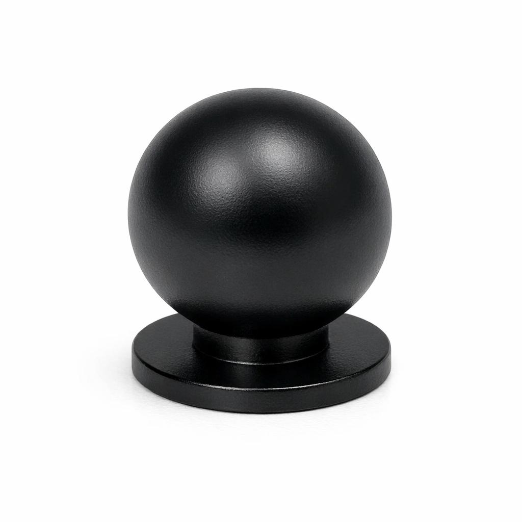 Commercial product photograph. A single residential cabinet knob. Smooth surface texture. Round Knob shape. Matte Black 