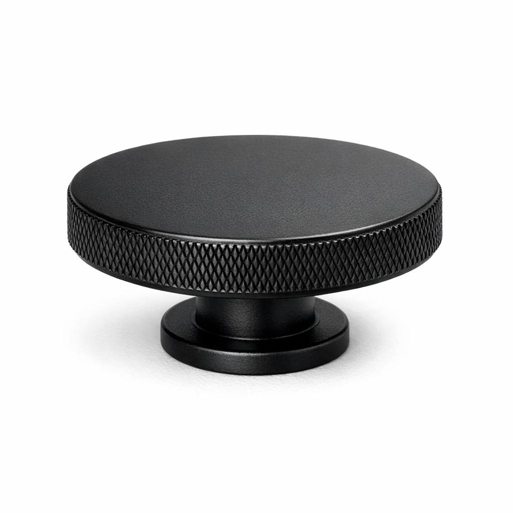 Commercial product photograph. A single residential cabinet knob. Knurled surface texture. Round Kno