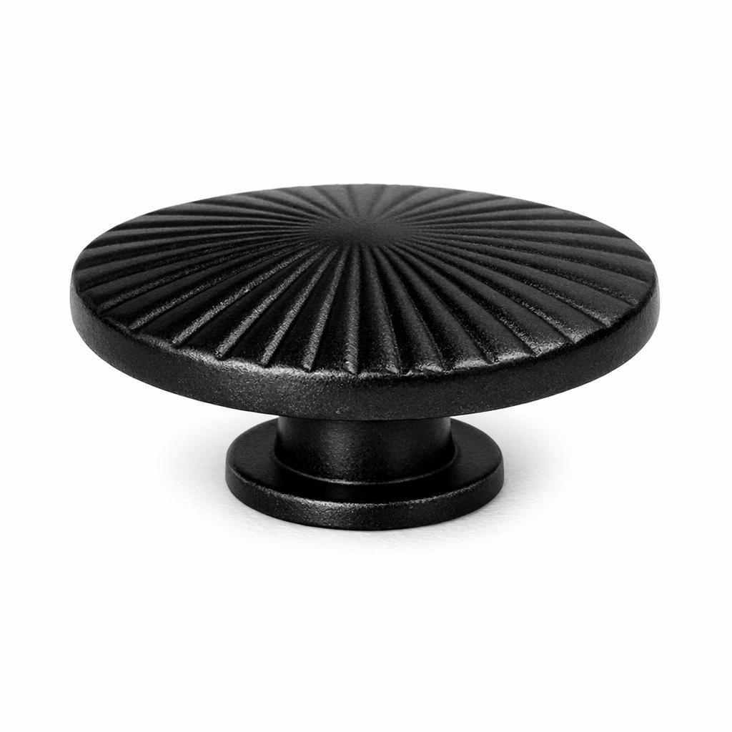 Commercial product photograph. A single residential cabinet knob. Ribbed surface texture. Round Knob shape. Matte Black 