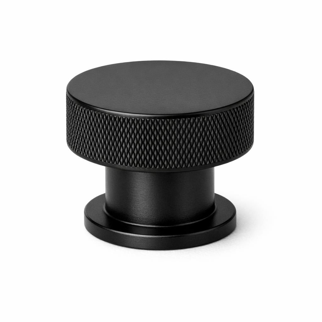Commercial product photograph. A single residential cabinet knob. Knurled surface texture. Round Kno