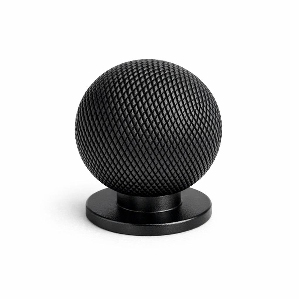 Commercial product photograph. A single residential cabinet knob. Knurled surface texture. Round Kno