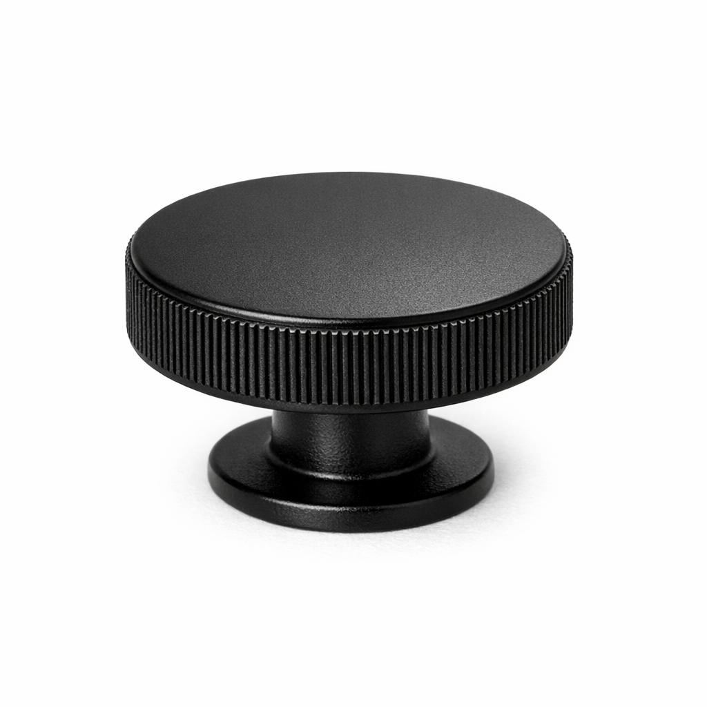 Commercial product photograph. A single residential cabinet knob. Knurled surface texture. Round Kno