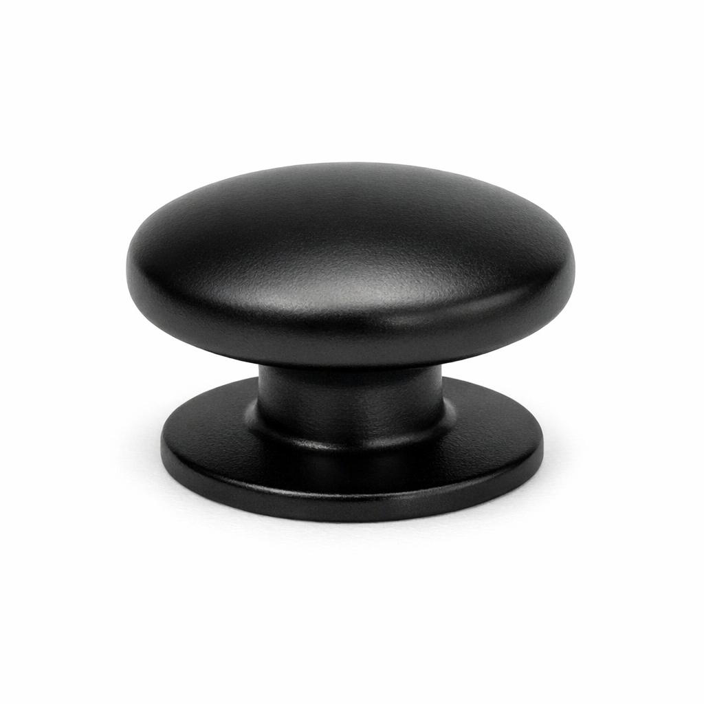 Commercial product photograph. A single residential cabinet knob. Smooth surface texture. Round Knob shape. Matte Black metal finish. Small circular base plate, single mounting post, approximately 1-1/4 inch diameter. Photographed on pure white seamless background (#FFFFFF). Studio softbox lighting, soft shadow directly underneath only. Macro lens, sharp focus throughout. Photorealistic real metal hardware. Not a 3D render. Not an illustration. Not CGI. Real cabinet hardware product photography quality. Variation 2: Round cabinet knob. Smooth dome top, slightly wider and flatter than standard, short neck, wide circular base plate. Low profile style..