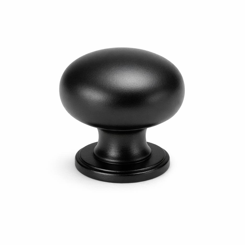 Commercial product photograph. A single residential cabinet knob. Smooth surface texture. Round Knob shape. Matte Black metal finish. Small circular base plate, single mounting post, approximately 1-1/4 inch diameter. Photographed on pure white seamless background (#FFFFFF). Studio softbox lighting, soft shadow directly underneath only. Macro lens, sharp focus throughout. Photorealistic real metal hardware. Not a 3D render. Not an illustration. Not CGI. Real cabinet hardware product photography quality. Variation 1: Classic round cabinet knob. Smooth dome top, short cylindrical neck, round base plate with beveled edge. Standard residential hardware proportions..