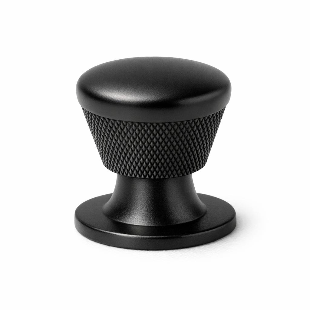 Commercial product photograph. A single residential cabinet knob. Knurled surface texture. Round Kno