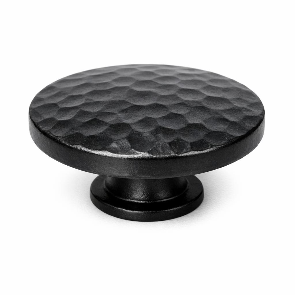 Commercial product photograph. A single residential cabinet knob. Hammered surface texture. Round Kn