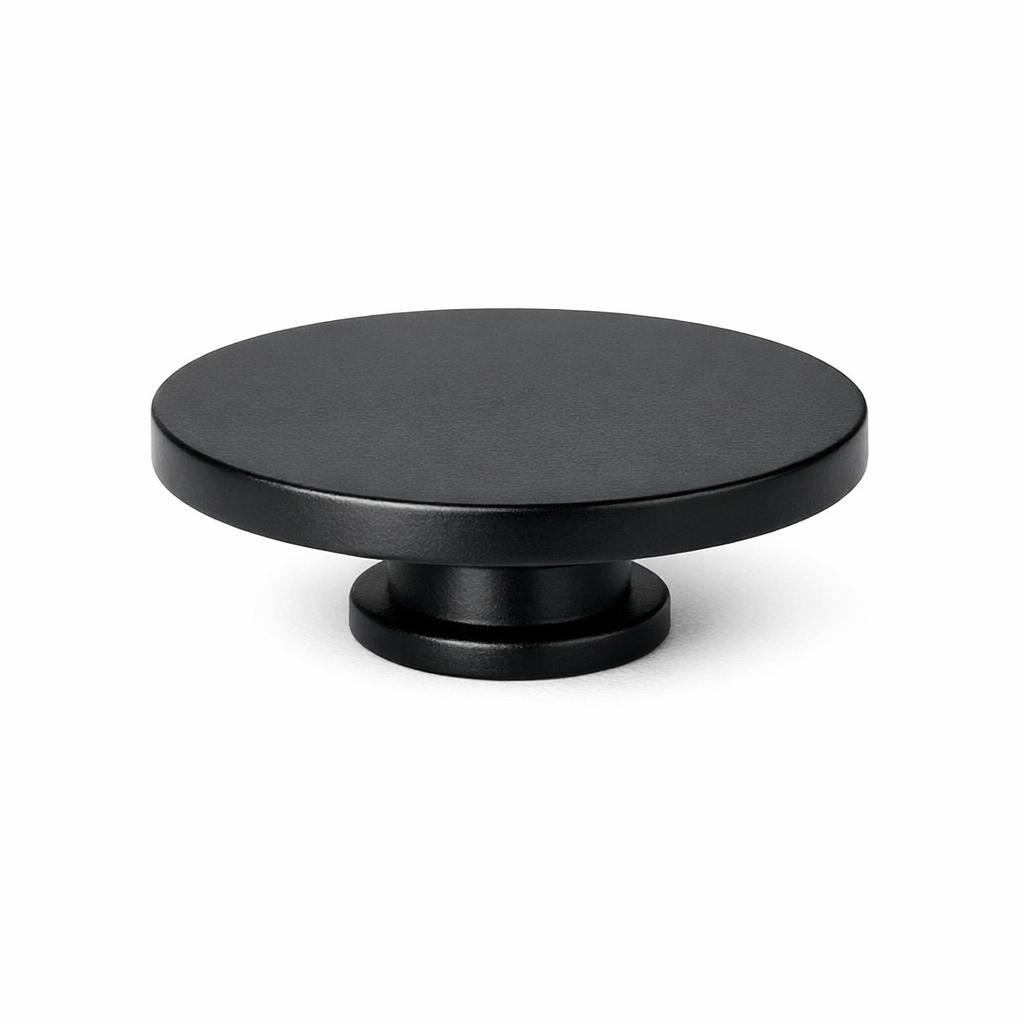 Commercial product photograph. A single residential cabinet knob. Smooth surface texture. Round Knob shape. Matte Black 