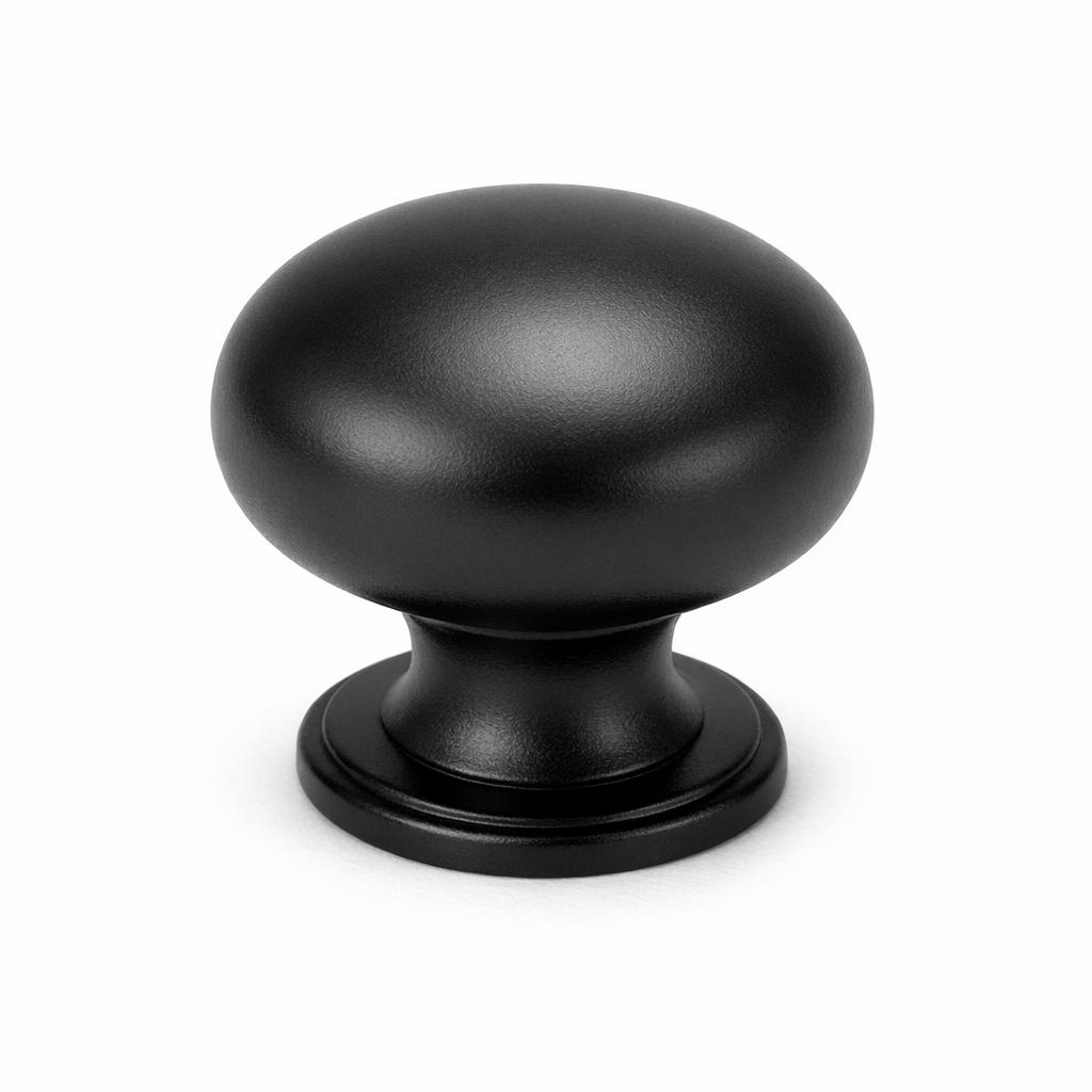 Commercial product photograph. A single residential cabinet knob. Smooth surface texture. Round Knob shape. Matte Black metal finish. Small circular base plate, single mounting post, approximately 1-1/4 inch diameter. Photographed on pure white seamless background (#FFFFFF). Studio softbox lighting, soft shadow directly underneath only. Macro lens, sharp focus throughout. Photorealistic real metal hardware. Not a 3D render. Not an illustration. Not CGI. Real cabinet hardware product photography quality. Variation 3: Round cabinet knob. Smooth full dome top, medium neck with slight taper, circular base plate with subtle lip edge..