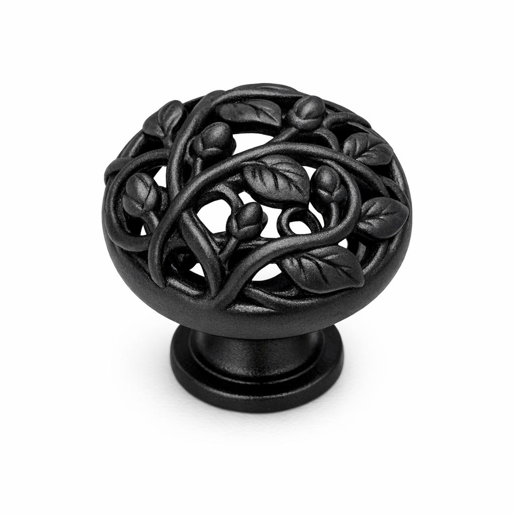 Commercial product photograph. A single residential cabinet knob. Floral surface texture. Round Knob shape. Matte Black metal finish. Small circular base plate, single mounting post, approximately 1-1/4 inch diameter. Photographed on pure white seamless background (#FFFFFF). Studio softbox lighting, soft shadow directly underneath only. Macro lens, sharp focus throughout. Photorealistic real metal hardware. Not a 3D render. Not an illustration. Not CGI. Real cabinet hardware product photography quality. Variation 8: Cabinet knob sculpted as a climbing vine, twisting stems with small buds and dimensional leaves wrapping around the form, openwork botanical relief, small round base. Cast metal floral hardware..
