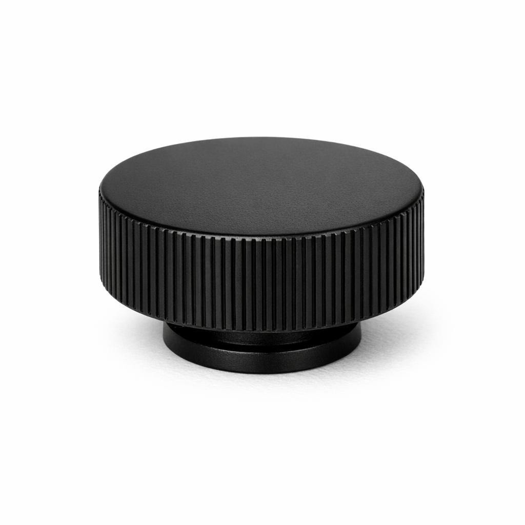 Commercial product photograph. A single residential cabinet knob. Ribbed surface texture. Round Knob shape....