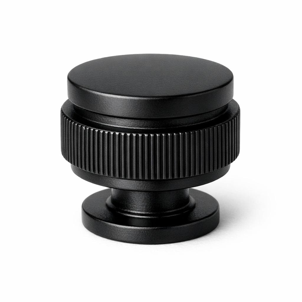 Commercial product photograph. A single residential cabinet knob. Ribbed surface texture. Round Knob shape. Matte Black 