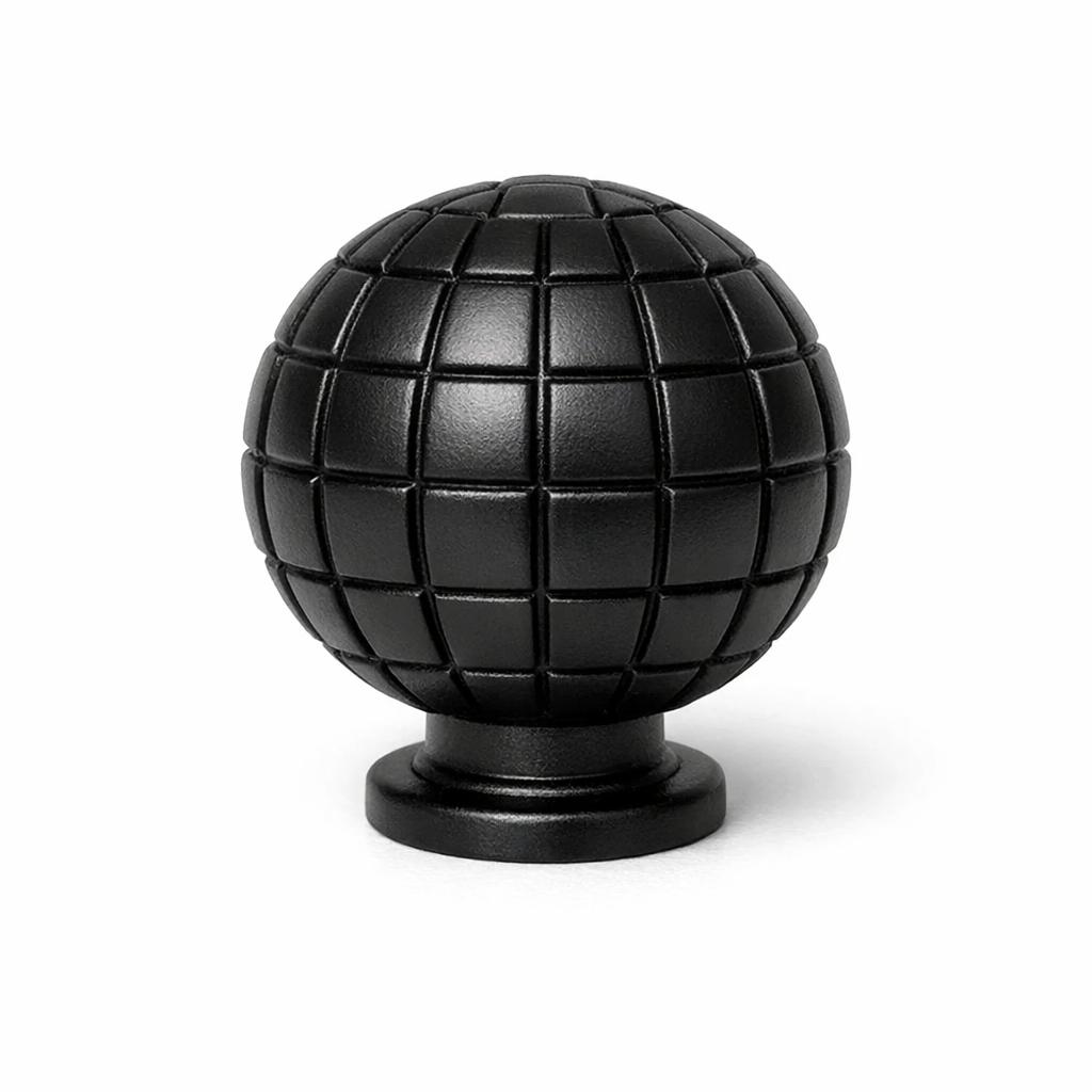 Commercial product photograph. A single residential cabinet knob. Geometric surface texture. Round K