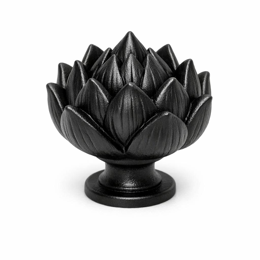Commercial product photograph. A single residential cabinet knob. Floral surface texture. Round Knob shape. Matte Black metal finish. Small circular base plate, single mounting post, approximately 1-1/4 inch diameter. Photographed on pure white seamless background (#FFFFFF). Studio softbox lighting, soft shadow directly underneath only. Macro lens, sharp focus throughout. Photorealistic real metal hardware. Not a 3D render. Not an illustration. Not CGI. Real cabinet hardware product photography quality. Variation 7: Cabinet knob sculpted as a lotus or water lily, pointed petals curving upward and inward to a peak, deeply dimensional layered petals, small round base. Cast metal floral hardware..